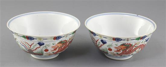 A pair of Chinese wucai dragon and phoenix bowls, Qianlong mark and of the period (1736-95), diameter 15.6cm, some damage